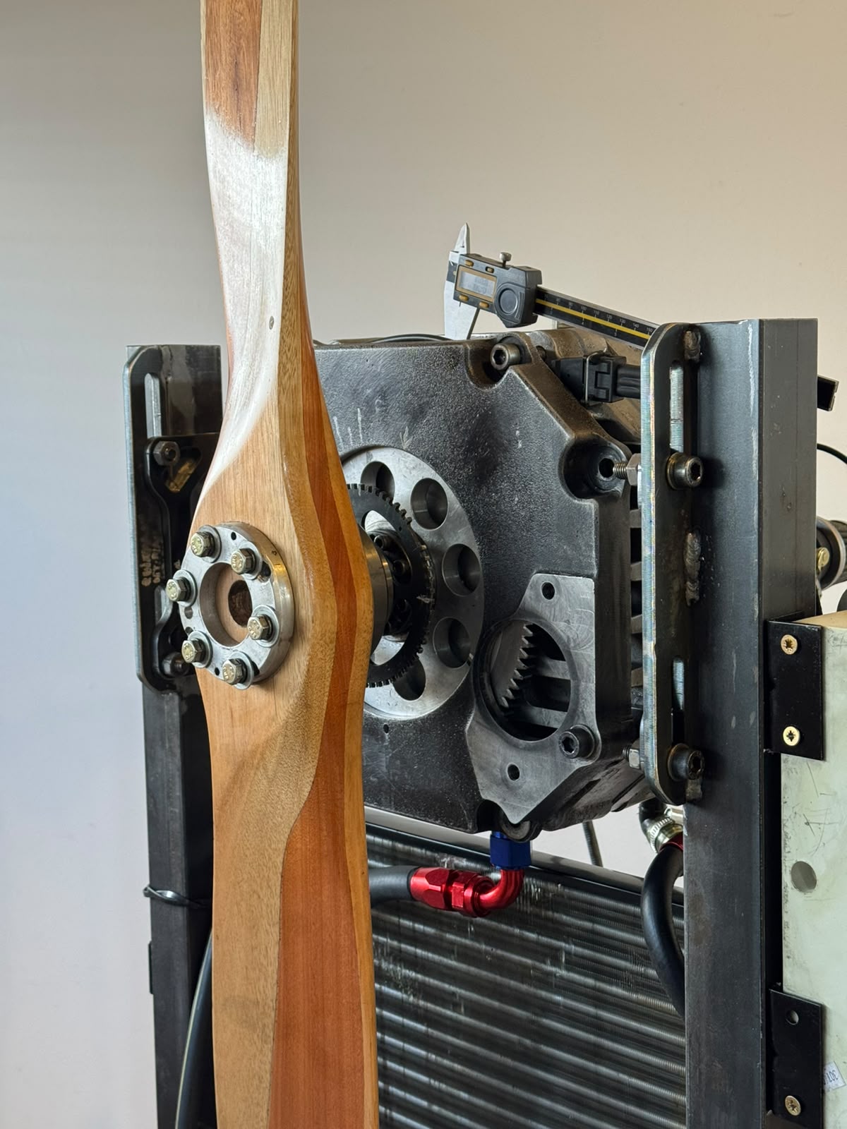 Open Engine Core showing the internal rotary mechanism being measured with a digital caliper